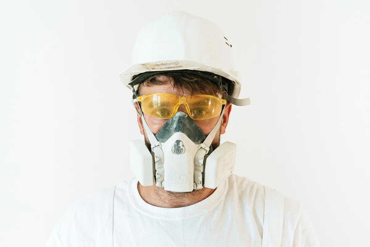 Worker wearing an industrial respirator mask